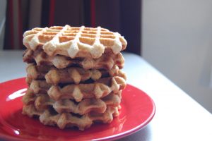 A stack of liege waffles on a red plate.