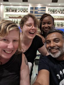 Four smiling people at a restaurant